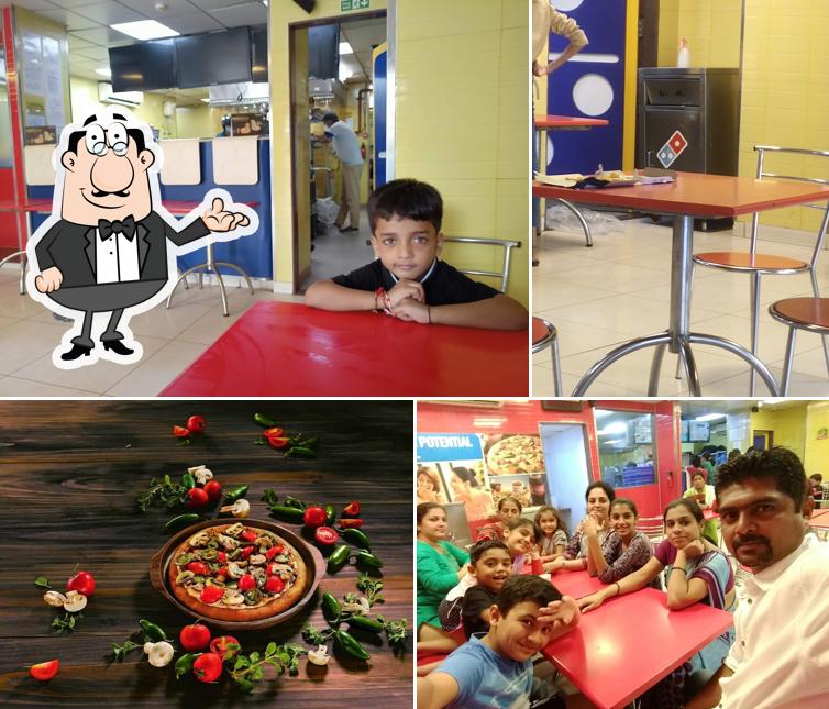 Take a seat at one of the tables at Domino's Pizza Vasanth Nagar, Thane