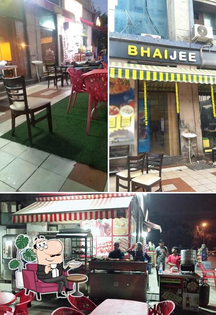 Take a seat at one of the tables at Bhai Jee Restaurant