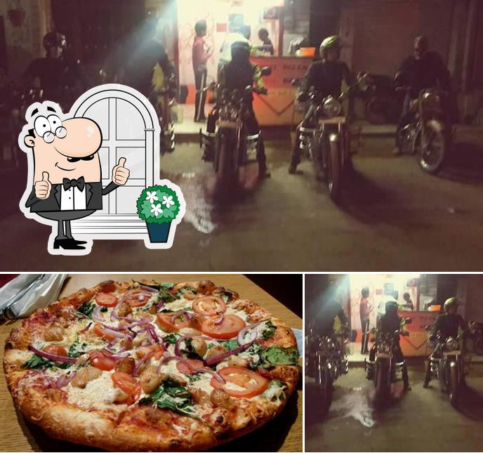 This is the photo showing exterior and pizza at Aahar Snacks Parlour