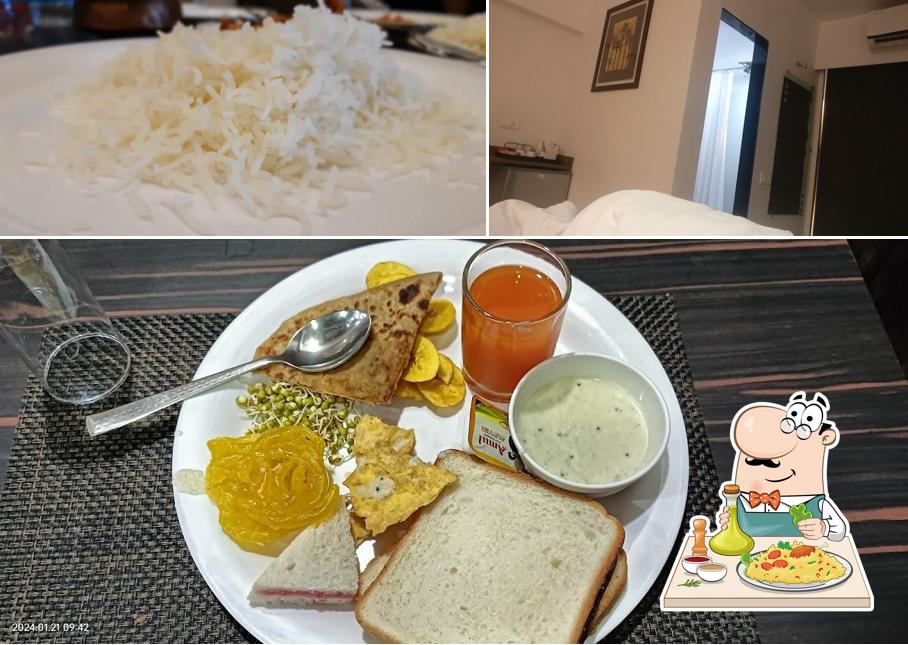 Take a look at the image displaying food and interior at Budget Inn Palm Regency, Vapi