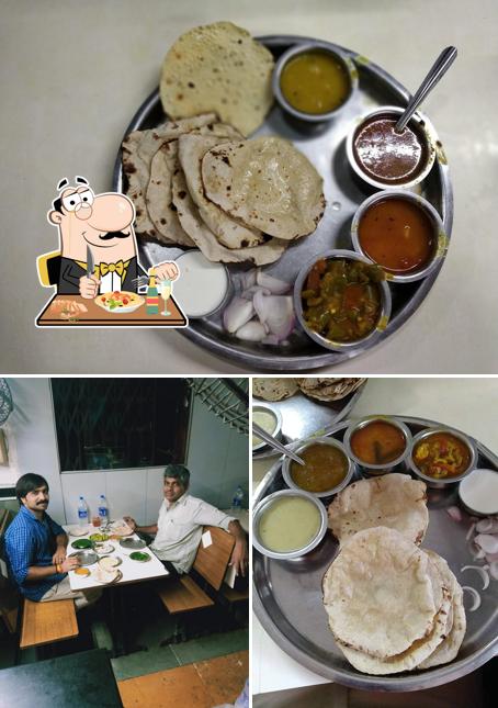 The photo of Hotel Tulsi Kathiyawadi’s food and dining table
