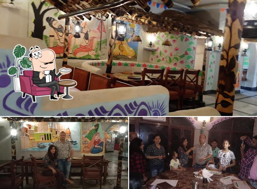 Take a seat at one of the tables at Chulha Chouki Restaurant