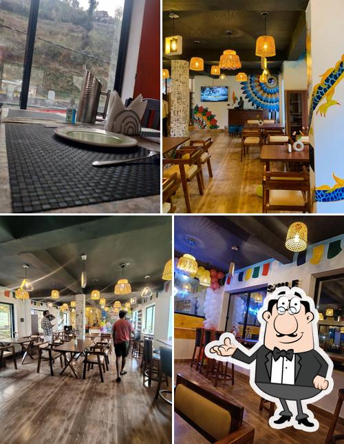 Take a seat at one of the tables at Darjeeling Cafe&Stay