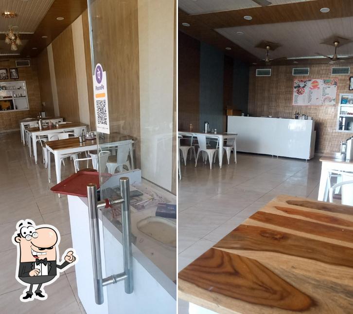 Take a seat at one of the tables at Prabhuji Restaurant