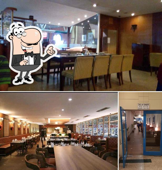 Take a seat at one of the tables at Delhi Dinner - Clarks Inn Hotel