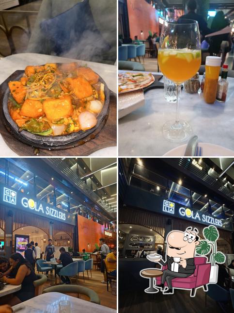 Take a seat at one of the tables at Gola Sizzlers, Saket