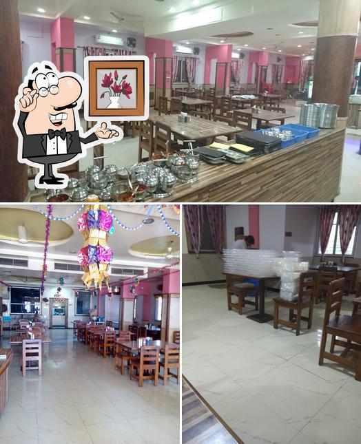Take a seat at one of the tables at KRISHNA GARDEN RESTAURANT