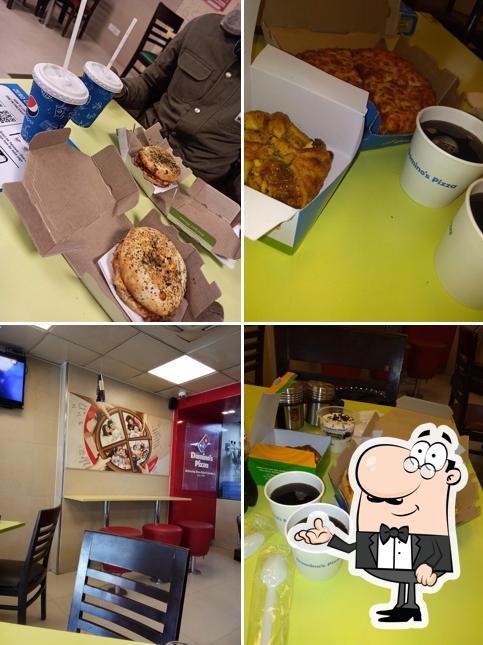 Take a seat at one of the tables at Domino's Pizza Niranjanpur, Dehradun