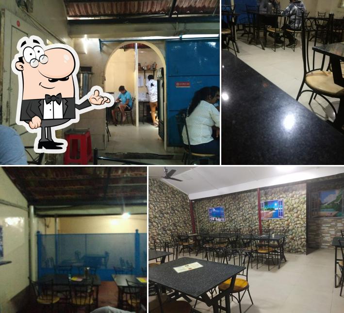 Take a seat at one of the tables at New Punjabi Hotel