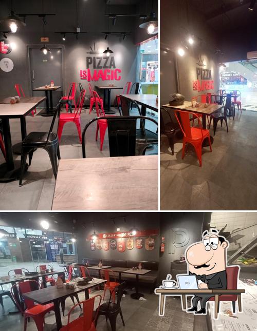 Take a seat at one of the tables at Pizza Hut CMR Mall, Vizag