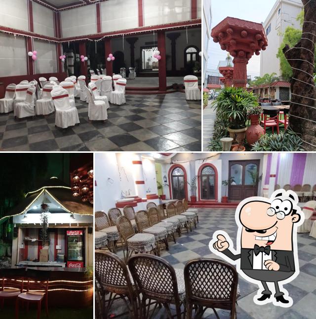 Take a seat at one of the tables at Abhishek Prime Hotel and Restaurant