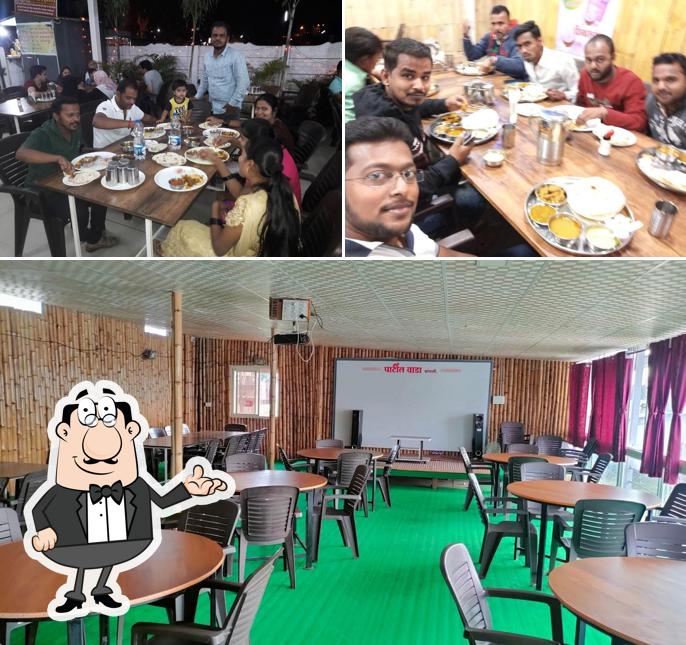 Check out the picture showing interior and dining table at Patil Wada