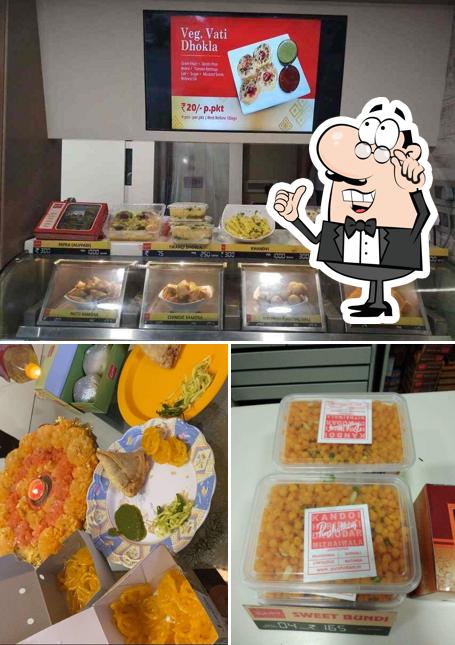 This is the picture displaying interior and food at Purshottam Kandoi Haribhai Damodar Mithaiwala