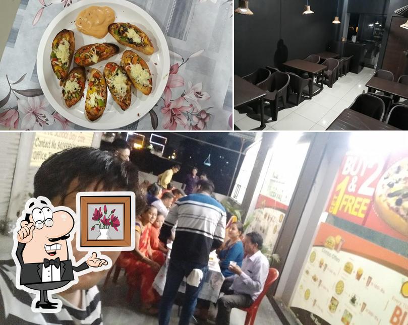 The photo of The kitchen restaurant’s interior and pizza