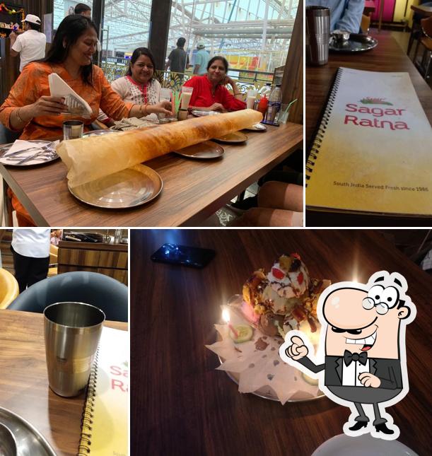 Take a seat at one of the tables at Sagar Ratna Omaxe Connaught Place