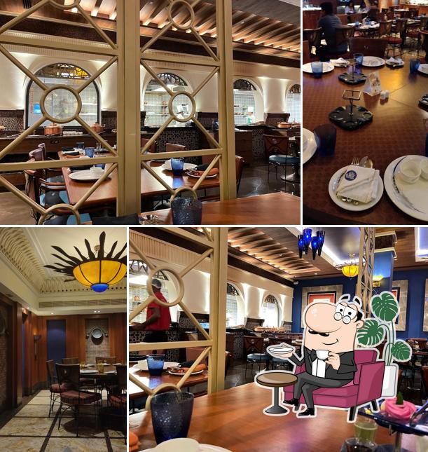 Take a seat at one of the tables at The Great Kabab Factory - Radisson Blu Egmore