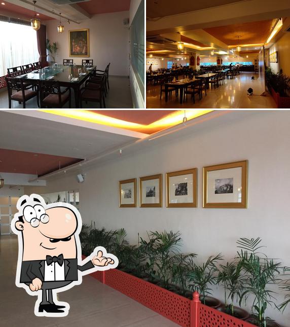 Take a seat at one of the tables at Banaras Fine Dine and Lounge