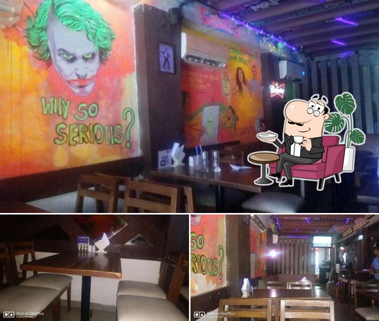 Take a seat at one of the tables at Booze On Moods - The Sports Bar