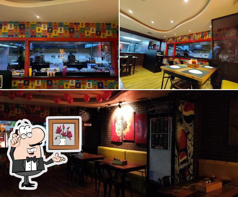 Take a seat at one of the tables at Superstar Pizza - Pure Veg