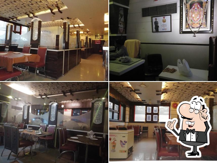 Take a seat at one of the tables at Gopi Ruchira Pure Veg. Restaurant