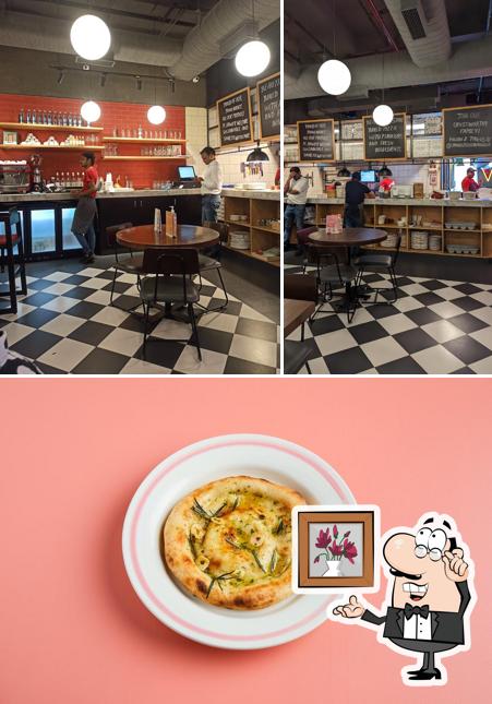 Take a look at the photo depicting interior and food at Jamie's Pizzeria by Jamie Oliver