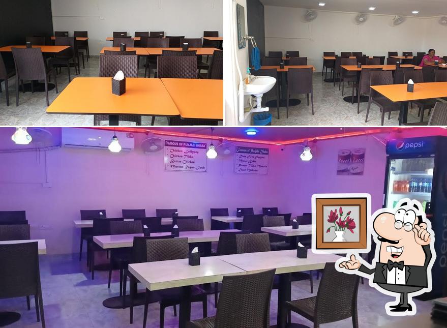 Take a seat at one of the tables at Punjabi Dhaba Veg Non-veg