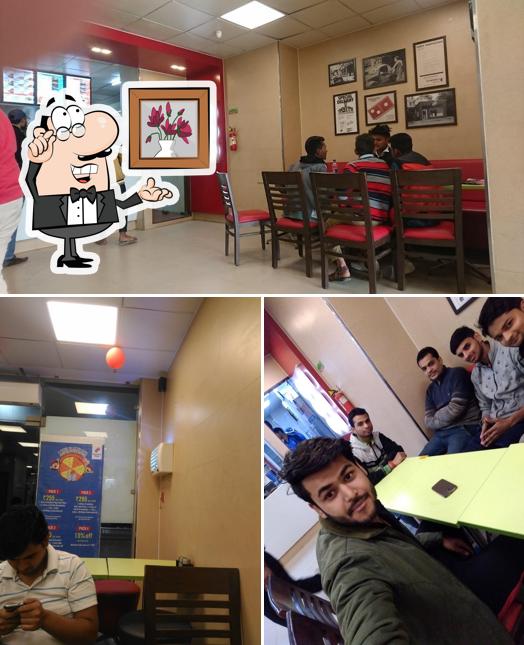 Take a seat at one of the tables at Domino's Pizza Arjun Nagar, Hapur