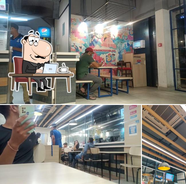 Take a seat at one of the tables at Domino's Pizza R. J. Puram, Gwalior