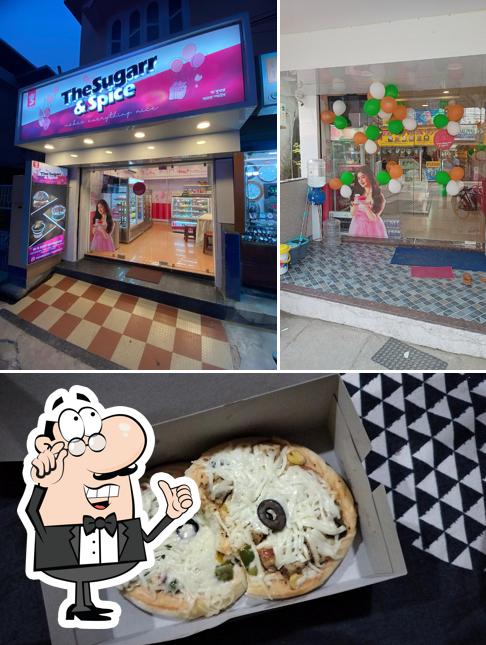 Take a look at the picture depicting interior and pizza at The Sugarr & Spice