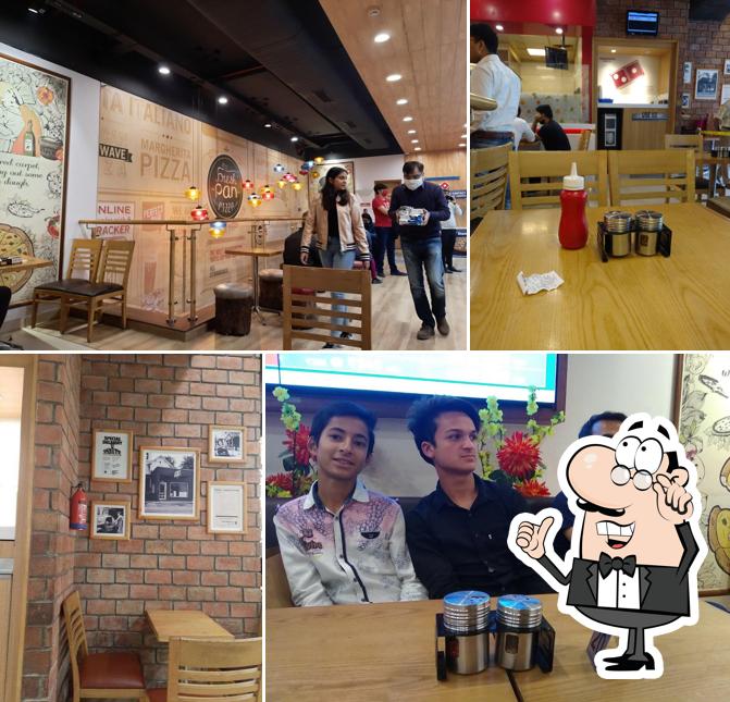 Take a seat at one of the tables at Domino's Pizza Janakpuri, New Delhi