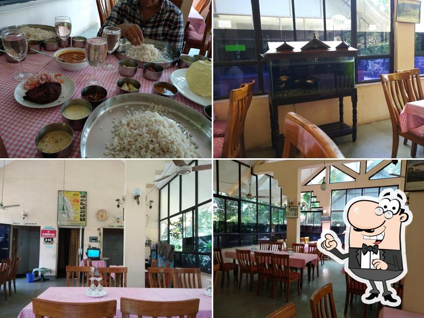 Take a seat at one of the tables at KTDC Aahaar Restaurant & Rooms