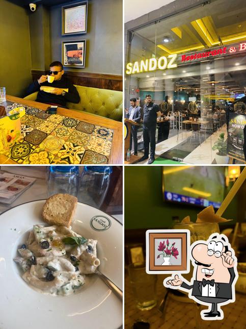 Take a seat at one of the tables at Sandoz Restaurant - L Block, CP