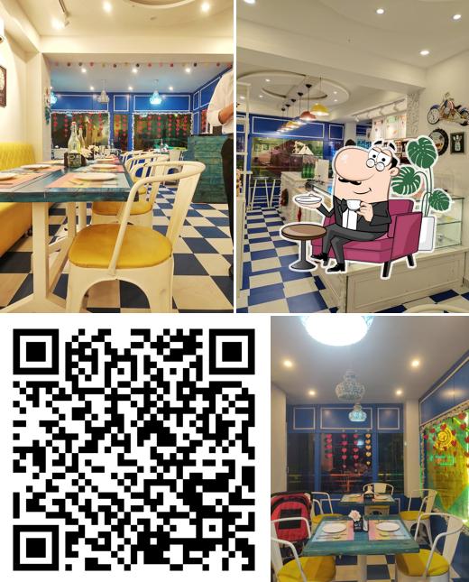 Take a seat at one of the tables at Happy Belly's Mehfil Restaurant ---A Multicuisine Restaurant