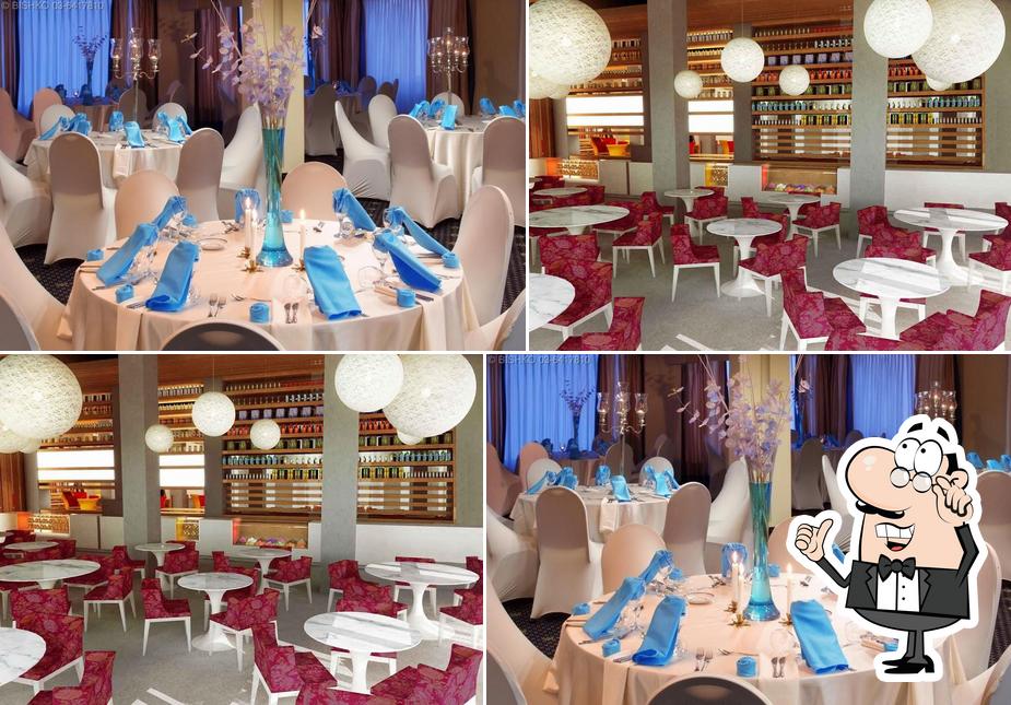 Take a seat at one of the tables at Sri Murugan Cafe and Hotels