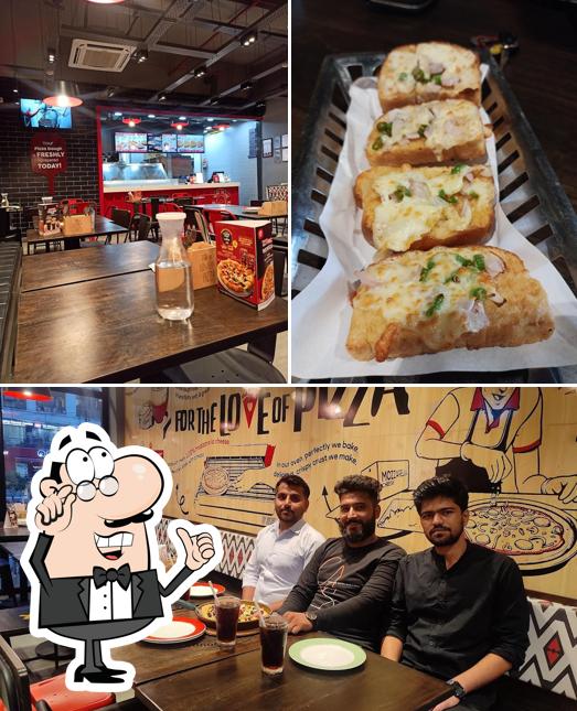 This is the image showing interior and food at Pizza Hut Annapurna, Indore