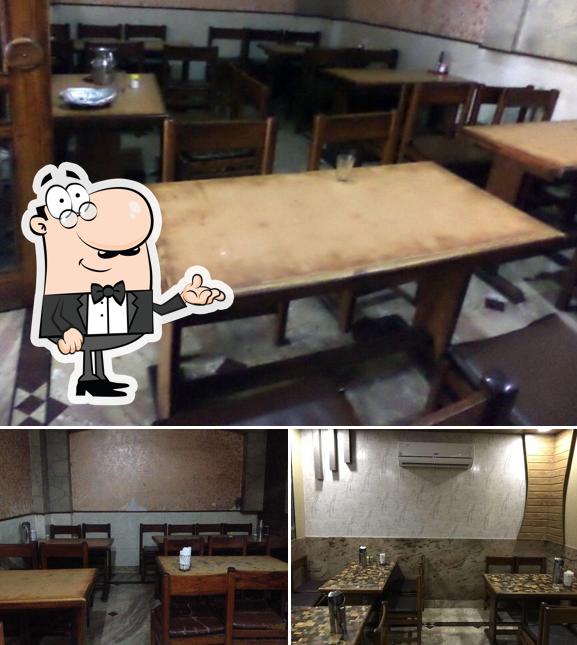 Take a seat at one of the tables at Kumar Hotel