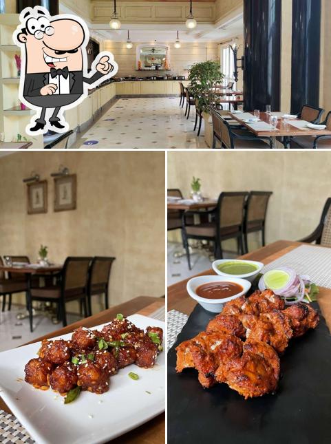 Take a seat at one of the tables at The Brasserie By Hilton Mumbai