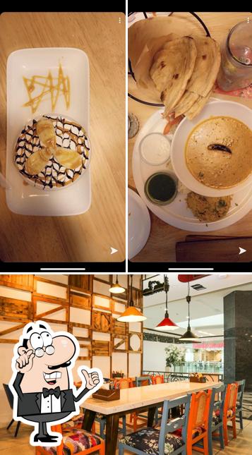 Take a look at the photo showing interior and dining table at Cafe Delhi Heights