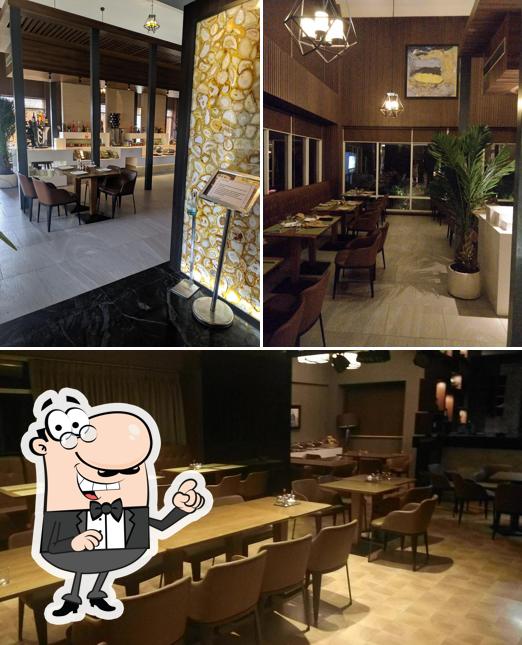 Take a seat at one of the tables at Little Italy Restaurant, Lullanagar Pune