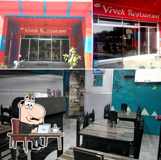 Take a seat at one of the tables at New Vivek Restaurant
