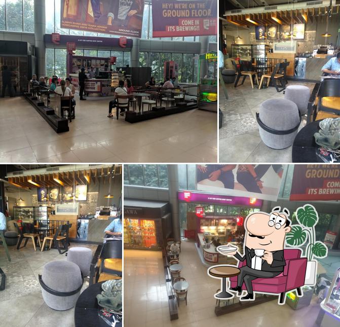 Take a seat at one of the tables at Café Coffee Day