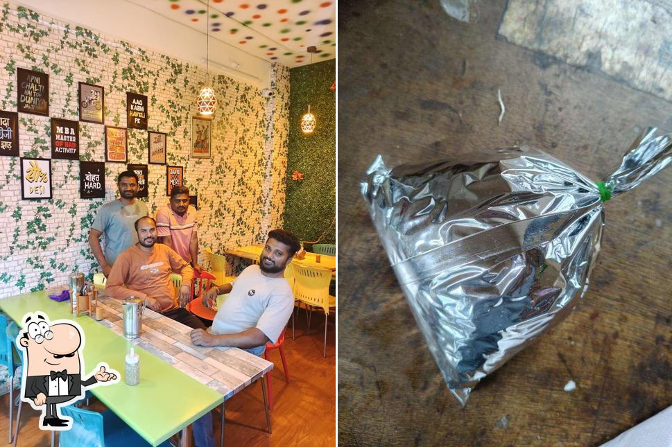 Take a seat at one of the tables at RUCHI SNACKS & RESTAURANT