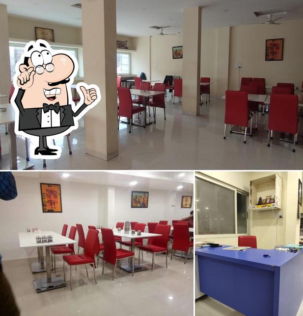 Take a seat at one of the tables at Arihant Dal Bati