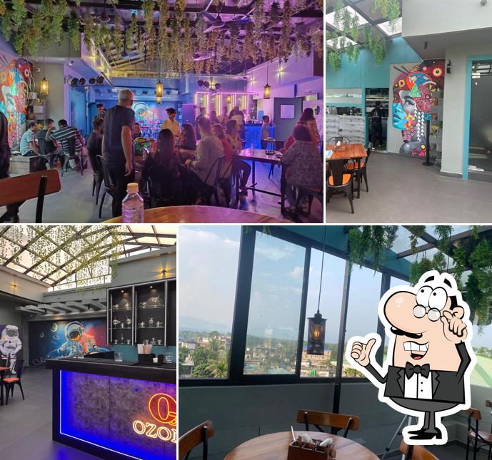 Take a seat at one of the tables at Ozone Rooftop Restro Lounge