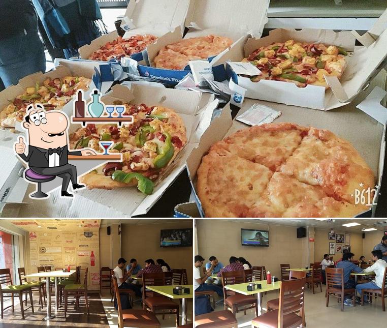 Check out the image displaying interior and food at Domino's Pizza Patel Nagar, Gwalior
