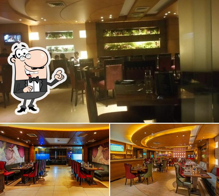 Take a seat at one of the tables at The Yellow Chilli - Sarabha Nagar, Ludhiana