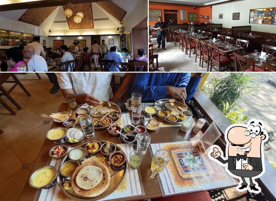 Take a seat at one of the tables at Chetana Veg. Restaurant & Bar (1946)