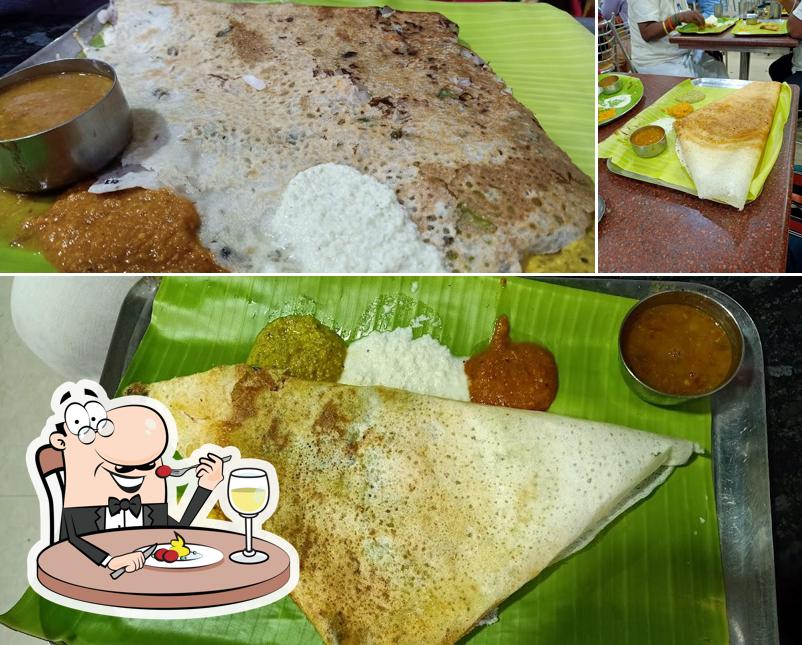This is the photo displaying food and dining table at Hotel Vasantham