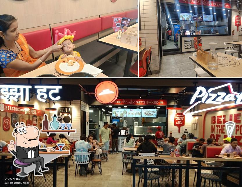 Take a seat at one of the tables at Pizza Hut Lawate Nagar, Nashik