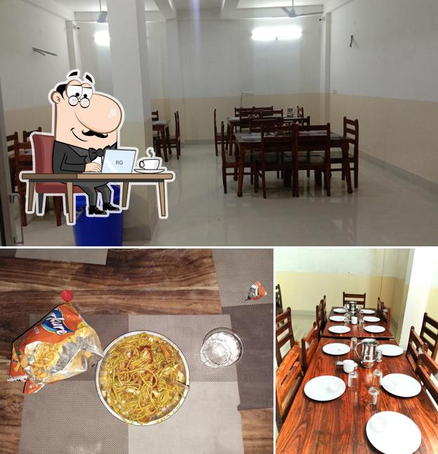 Take a seat at one of the tables at TRINETRA VINAYAK RESTAURANT